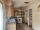 Outdated kitchen with dated cabinets, appliances and worn countertops at 2810 Kumquat Dr, Edgewater, FL 32141