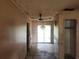 Empty living room with tile floor, ceiling fan, sliding glass doors, and neutral walls at 2810 Kumquat Dr, Edgewater, FL 32141