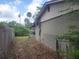 A side yard with a partial chain link fence and partial privacy fence at 2810 Kumquat Dr, Edgewater, FL 32141