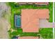 Aerial view of the property with pool, tile roof, brick driveway and mature landscaping at 2814 S Asciano Ct, New Smyrna Beach, FL 32168