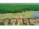 Aerial view of home with tile roof backing to golf course and trees at 2814 S Asciano Ct, New Smyrna Beach, FL 32168