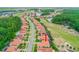 Aerial view of community with homes, lakes, golf courses and mature trees. Arrow points to property at 2814 S Asciano Ct, New Smyrna Beach, FL 32168
