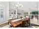 Open-concept dining room featuring a large wooden table and chandelier lighting at 2814 S Asciano Ct, New Smyrna Beach, FL 32168