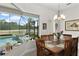 Dining room with backyard pool view and patio access at 2814 S Asciano Ct, New Smyrna Beach, FL 32168