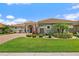 Inviting home featuring a tile roof, manicured lawn, and lush landscaping at 2814 S Asciano Ct, New Smyrna Beach, FL 32168