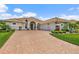 Beautiful home with tile roof, three car garage, mature landscaping and a brick driveway at 2814 S Asciano Ct, New Smyrna Beach, FL 32168