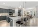 Stylish kitchen with gray cabinets, quartz countertops, stainless steel appliances and an island with seating at 2814 S Asciano Ct, New Smyrna Beach, FL 32168