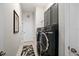 Convenient laundry room with sleek gray cabinetry and modern washer and dryer units at 2814 S Asciano Ct, New Smyrna Beach, FL 32168
