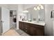 Well-lit main bathroom with double vanity, wood cabinets and tile flooring at 2814 S Asciano Ct, New Smyrna Beach, FL 32168