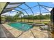Screened pool with a connected hot tub overlooking lush green lawns and trees at 2814 S Asciano Ct, New Smyrna Beach, FL 32168