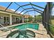 Gorgeous in-ground pool and hot tub area in a screened lanai with nearby seating at 2814 S Asciano Ct, New Smyrna Beach, FL 32168