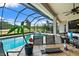Screened-in patio overlooking a pool and golf course, perfect for relaxing outdoors at 2814 S Asciano Ct, New Smyrna Beach, FL 32168