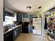 Functional kitchen with blue cabinets, black appliances, and an adjacent open pantry at 2816 Travelers Palm Dr, Edgewater, FL 32141