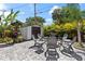Well-kept backyard with a fire pit surrounded by chairs with tropical landscaping at 2824 Oak Lea Dr, South Daytona, FL 32119