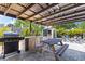 Well-kept backyard with an outdoor kitchen and firepit with tropical landscaping at 2824 Oak Lea Dr, South Daytona, FL 32119