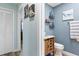 Hallway bathroom featuring a stylish vanity and decorative shelves at 2824 Oak Lea Dr, South Daytona, FL 32119