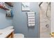 Stylish blue bathroom with a vanity and shower, complemented by unique decor at 2824 Oak Lea Dr, South Daytona, FL 32119