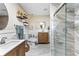 Updated bathroom featuring double sinks, stylish fixtures, and a glass-enclosed shower at 2824 Oak Lea Dr, South Daytona, FL 32119