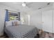 Well-lit bedroom with light walls, ceiling fan and wood floors at 2824 Oak Lea Dr, South Daytona, FL 32119
