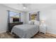 Cozy bedroom features wood floors, ceiling fan and two sunny windows at 2824 Oak Lea Dr, South Daytona, FL 32119