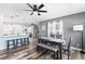 Open-concept dining area with modern lighting, stylish table set, and hardwood floors at 2824 Oak Lea Dr, South Daytona, FL 32119