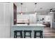 Beautiful kitchen featuring modern white cabinets, a kitchen island with stools and modern pendant lighting at 2824 Oak Lea Dr, South Daytona, FL 32119