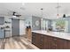 Open floor plan featuring kitchen island with bar stool seating, mini fridge and sliding barn door at 2824 Oak Lea Dr, South Daytona, FL 32119