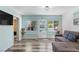 Bright and airy living room with views of the outdoor swimming pool area, modern light fixture and neutral paint at 2824 Oak Lea Dr, South Daytona, FL 32119