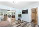 Open-concept living room with wood flooring, modern decor, and view to the kitchen at 2824 Oak Lea Dr, South Daytona, FL 32119