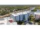 Aerial view of the condominium building and surrounding waterfront at 3 Riverwalk Dr # 202, New Smyrna Beach, FL 32169