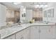 Spacious bathroom features double vanities with granite countertops, offering a luxurious and functional space at 3 Riverwalk Dr # 202, New Smyrna Beach, FL 32169