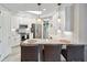 Bright, white kitchen with bar seating, stainless appliances, and modern finishes at 3 Riverwalk Dr # 202, New Smyrna Beach, FL 32169