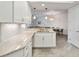 Bright kitchen features white cabinets, granite countertops, stainless steel appliances, and modern lighting fixtures at 3 Riverwalk Dr # 202, New Smyrna Beach, FL 32169
