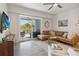 Comfortable living room featuring access to a private balcony with outdoor seating and tropical views at 3 Riverwalk Dr # 202, New Smyrna Beach, FL 32169