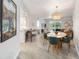 Open concept living space with dining area, kitchen, and balcony access at 3 Riverwalk Dr # 202, New Smyrna Beach, FL 32169