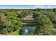 Gorgeous aerial shot of a home overlooking a serene pond with a fountain, all surrounded by lush greenery at 30 Reflections Village Dr, Ormond Beach, FL 32174