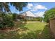 Expansive backyard with screened-in porch, manicured shrubs, and a fountain, perfect for outdoor relaxation at 30 Reflections Village Dr, Ormond Beach, FL 32174