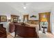 Bedroom with a traditional dark wooden bed set, ceiling fan, and large windows with decorative draperies at 30 Reflections Village Dr, Ormond Beach, FL 32174
