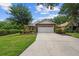 Charming single-story brick home with a well-manicured lawn and an attached two-car garage at 30 Reflections Village Dr, Ormond Beach, FL 32174