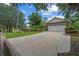 Brick home with a two-car garage, concrete driveway, and lush lawn and landscaping at 30 Reflections Village Dr, Ormond Beach, FL 32174
