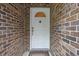 White front door of a brick home, featuring sidelights and a secure entryway at 30 Reflections Village Dr, Ormond Beach, FL 32174