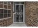 Close-up of a white decorative front door with brick and a window at 30 Reflections Village Dr, Ormond Beach, FL 32174