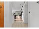 Bright hallway with tile flooring leading to a living room with a vaulted ceiling and wood floors at 30 Reflections Village Dr, Ormond Beach, FL 32174