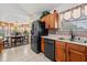 Kitchen with wood cabinets, black appliances, tile flooring and breakfast nook at 30 Reflections Village Dr, Ormond Beach, FL 32174