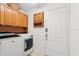 Practical laundry room with washer, dryer and ample overhead storage cabinets at 30 Reflections Village Dr, Ormond Beach, FL 32174