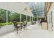 Spacious sun room features a ceiling fan, tile floors, and multiple seating areas with a view at 30 Reflections Village Dr, Ormond Beach, FL 32174