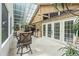 Bright sunroom with tile floor, brick wall, ceiling fans, and outdoor seating near the French doors at 30 Reflections Village Dr, Ormond Beach, FL 32174