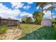 Spacious backyard featuring a shed, screened porch, and plenty of green space at 3107 Mapleshade St, Deltona, FL 32738