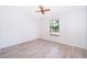 Comfortable bedroom featuring a ceiling fan and a view from the large window at 3107 Mapleshade St, Deltona, FL 32738