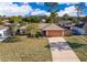 Charming single-story home boasts a large front yard, long driveway, and attached two-car garage at 3107 Mapleshade St, Deltona, FL 32738